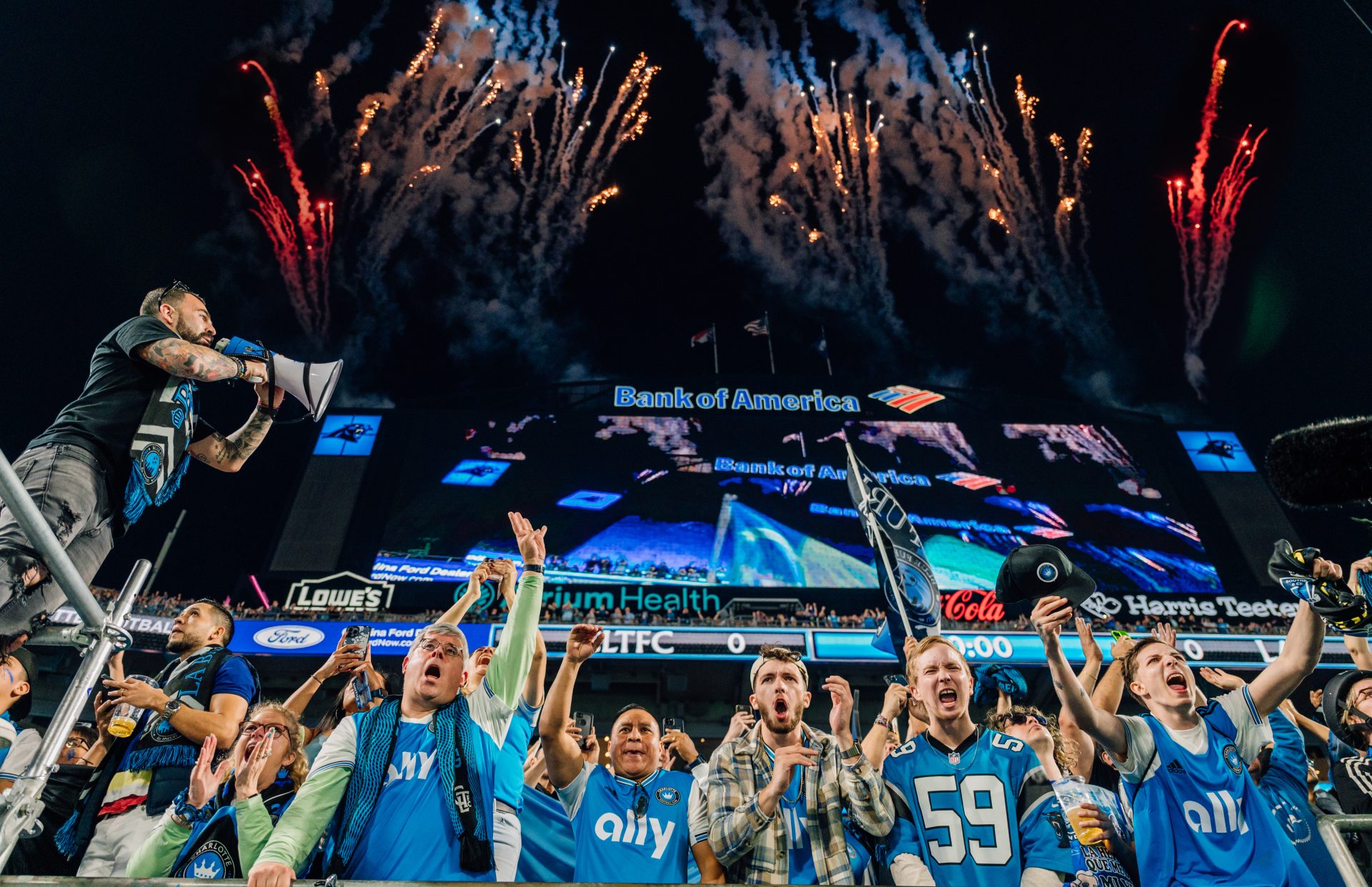 Charlotte FC Inaugural Match at Bank of America Stadium with passionate fans celebrating and fireworks lighting up the night sky