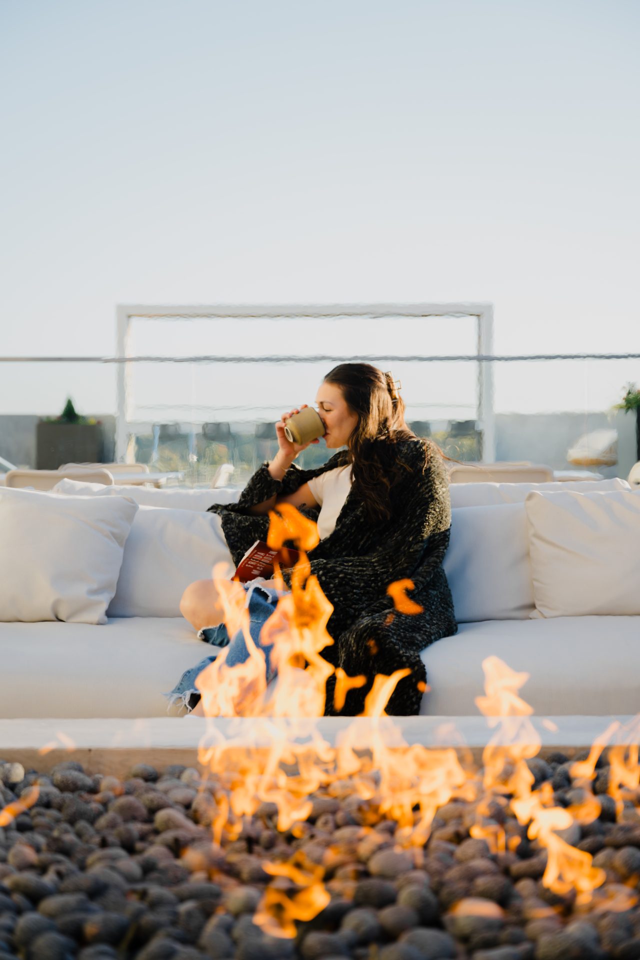 Romantic couple embracing near dramatic fire flames indoors for The Maeve own-channel content and brand identity project