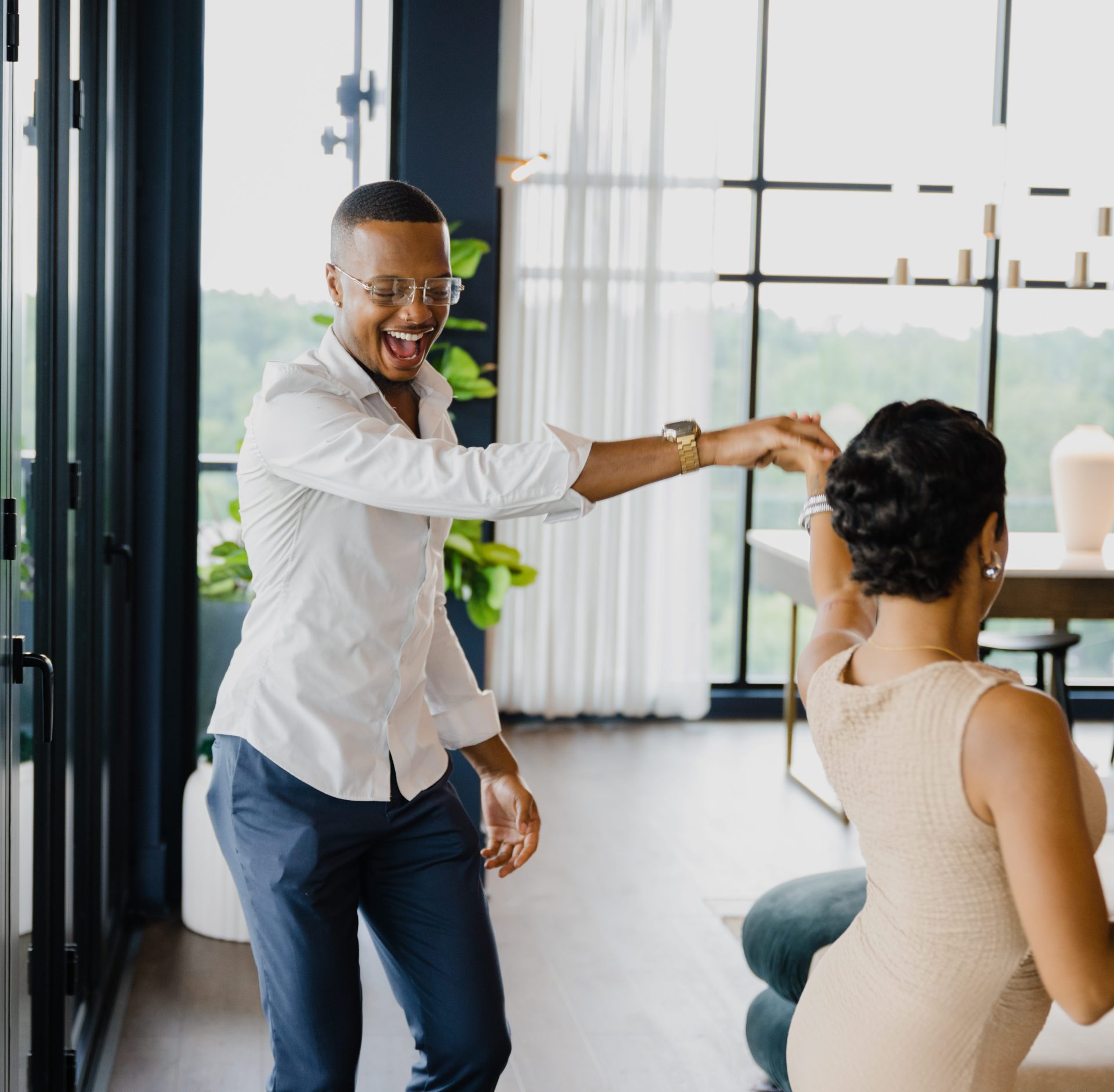 Couple dancing joyfully in a bright modern living space for The Rowe social strategy and narrative film campaign by Redefined