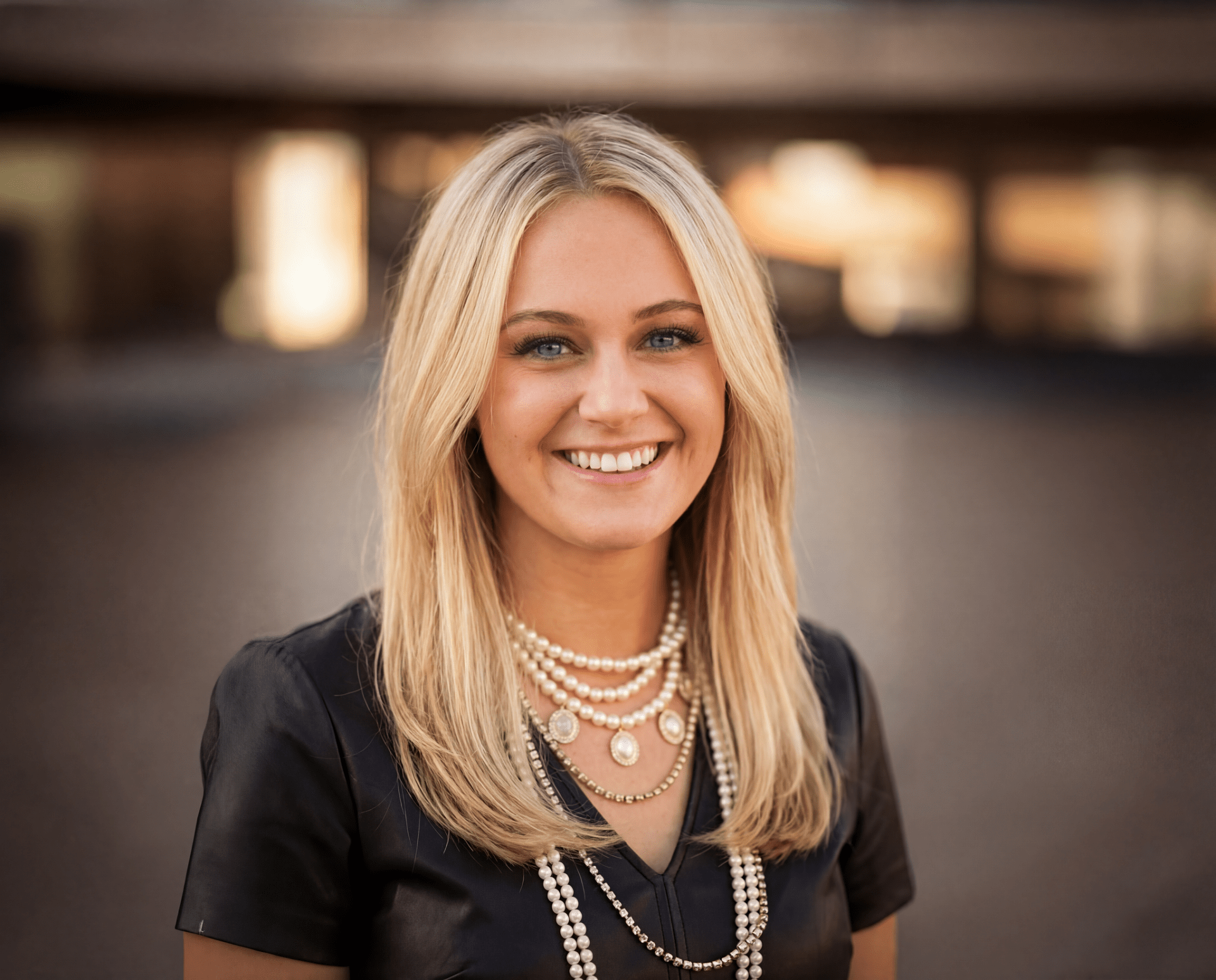 Miranda Birchfield, Social Media Manager at Redefined, smiling with blonde hair and pearl necklace in a professional portrait