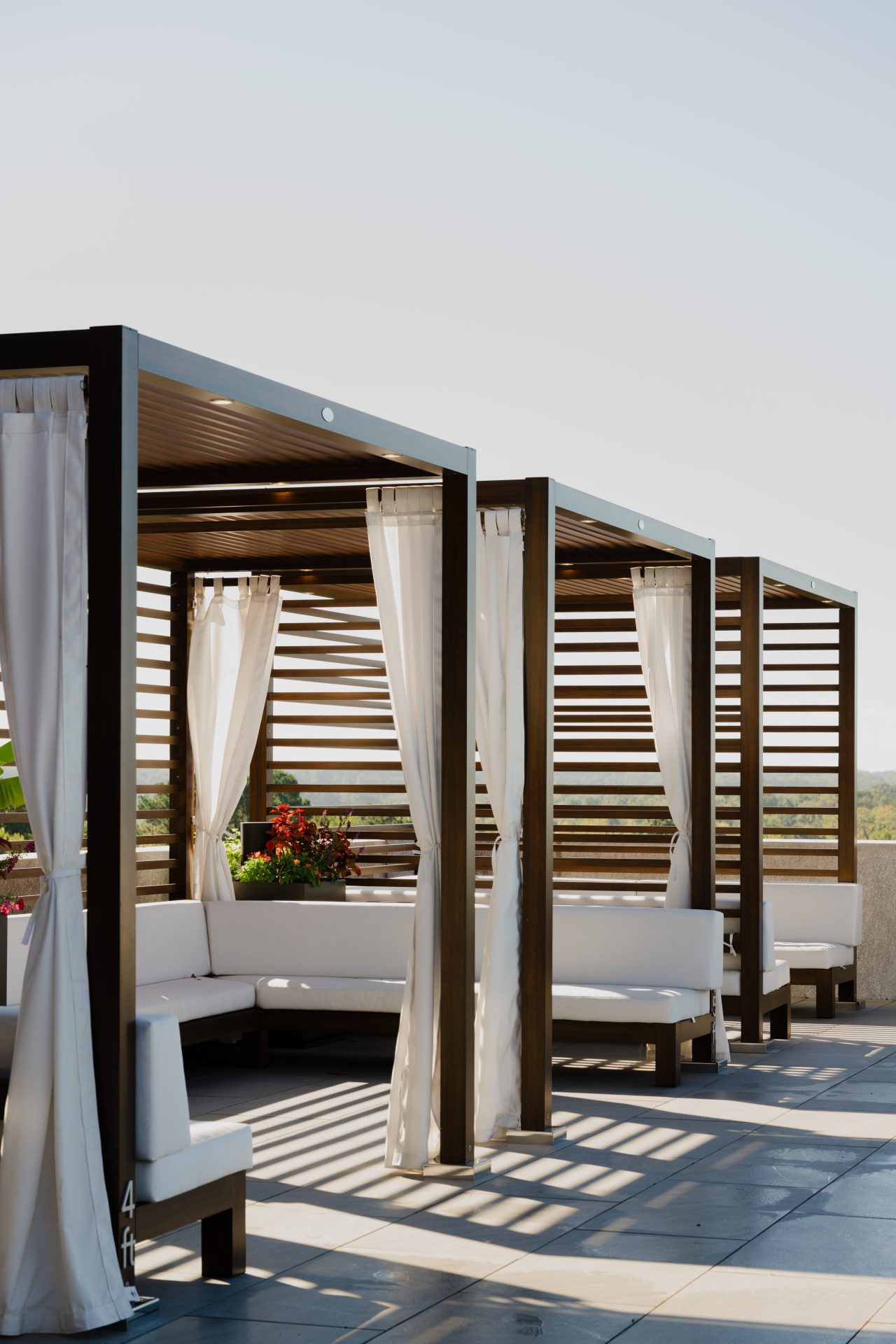 Shaded outdoor pergola lounge area at a luxury apartment community