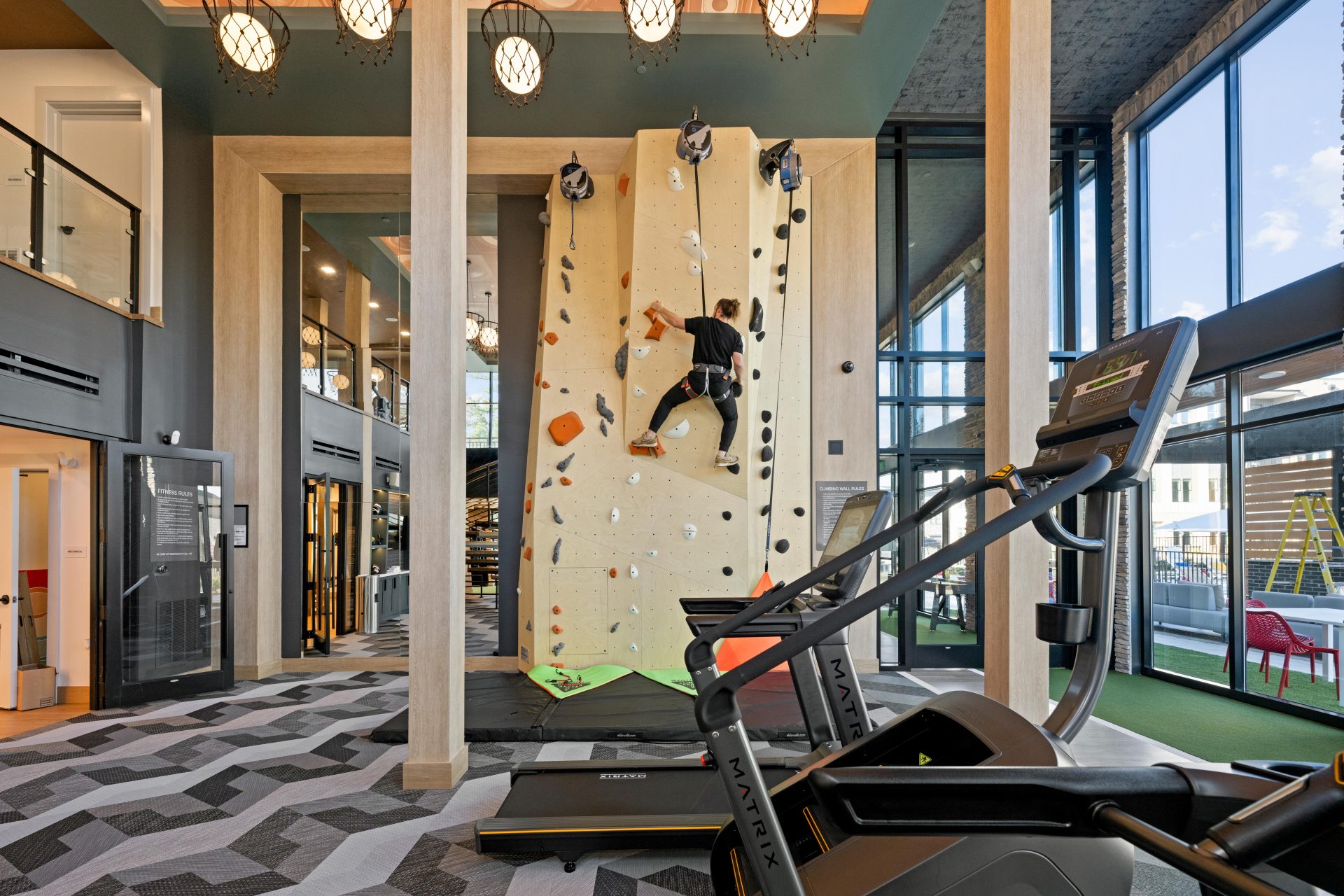 Resident using fitness equipment in a modern gym at NOVEL Morrisville Morrisville NC
