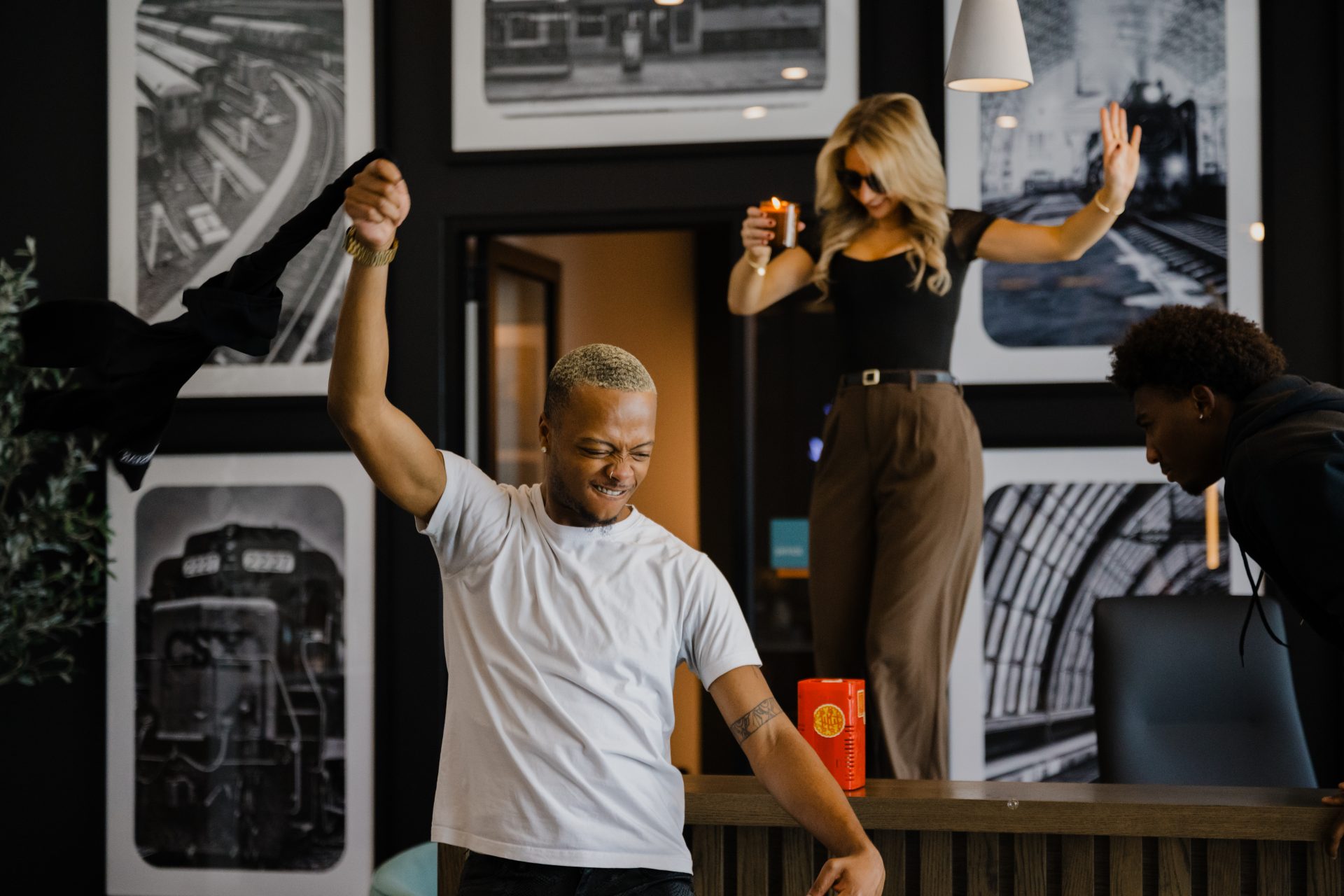 Residents laughing and dancing in a modern apartment living space