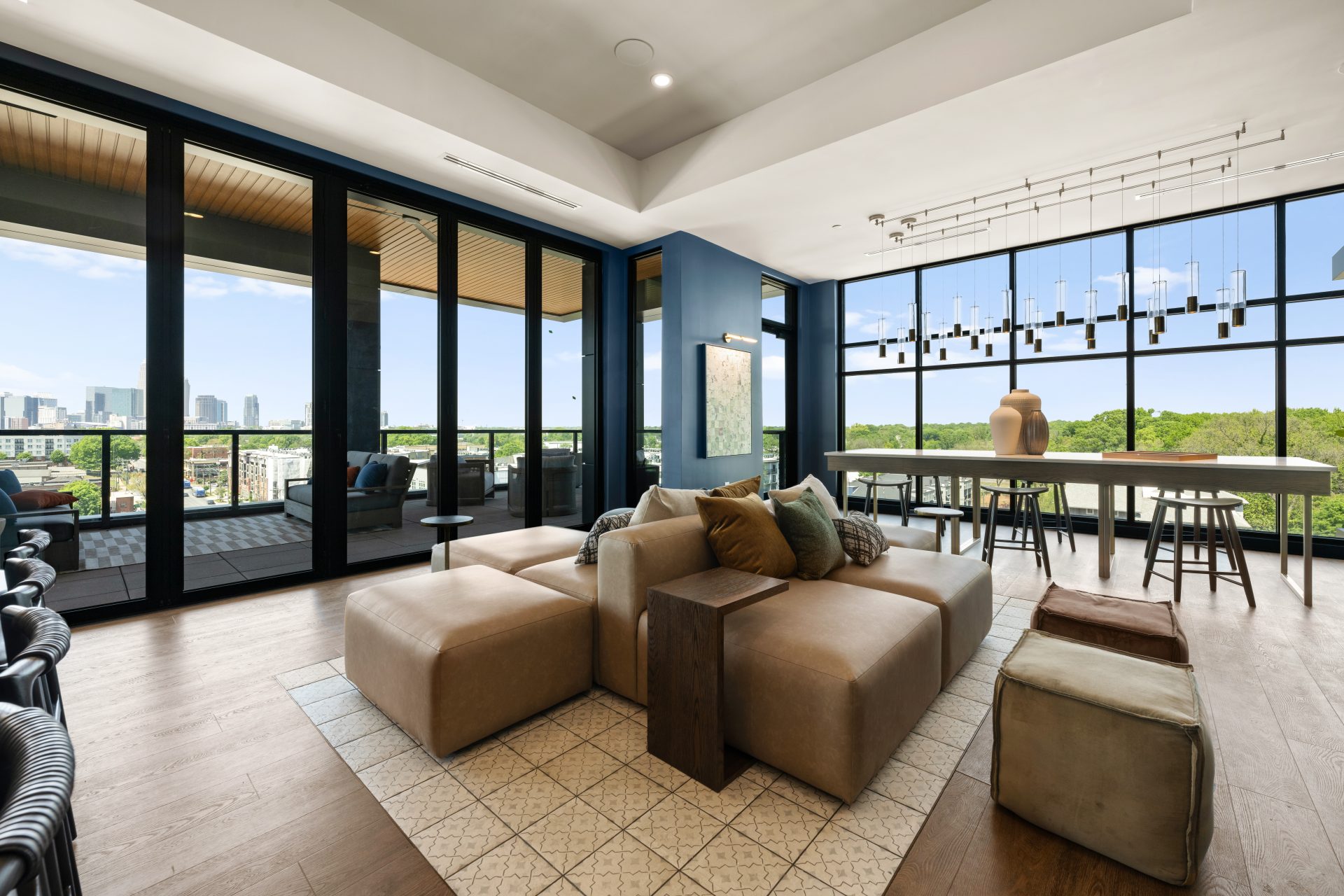 Spacious open-concept living room with panoramic city views